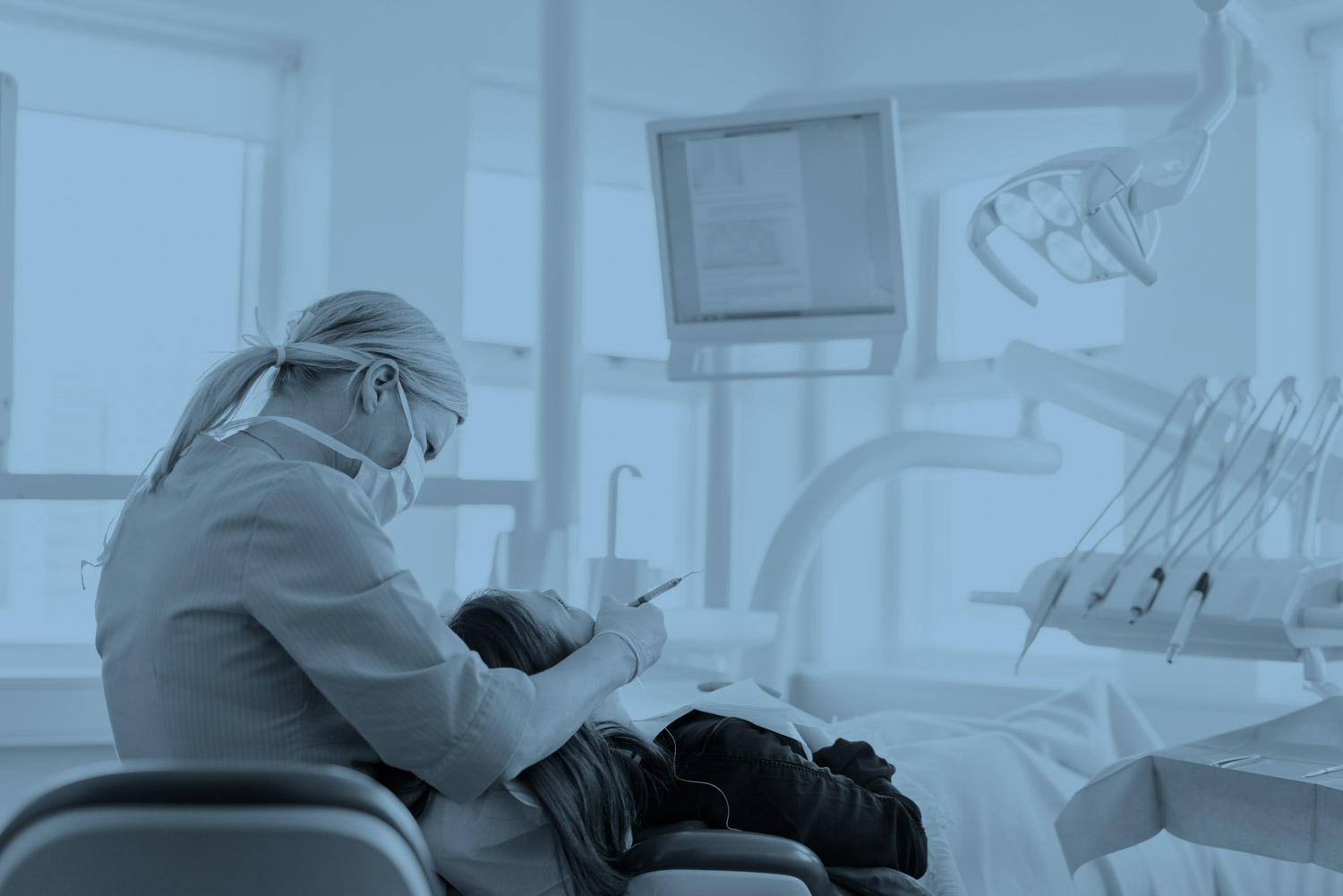 Dental hygienist working on patient.